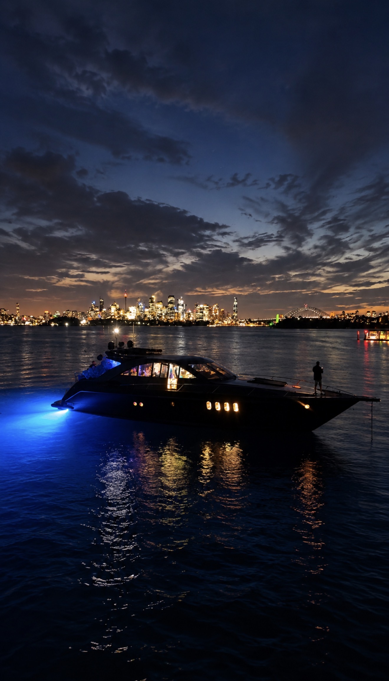 Prestige illuminated at night with the Sydney skyline